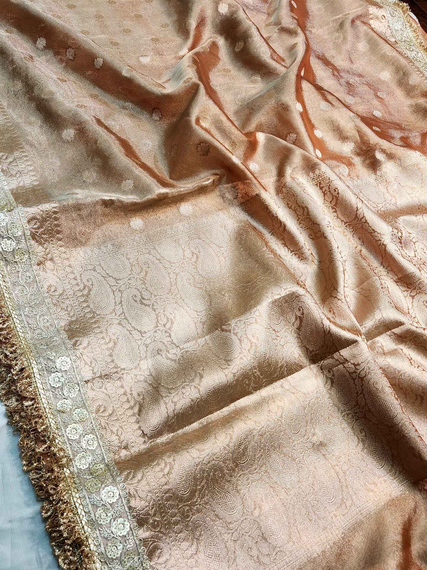Saheli Tissue silk Saree in metallic brown color with customised laces
