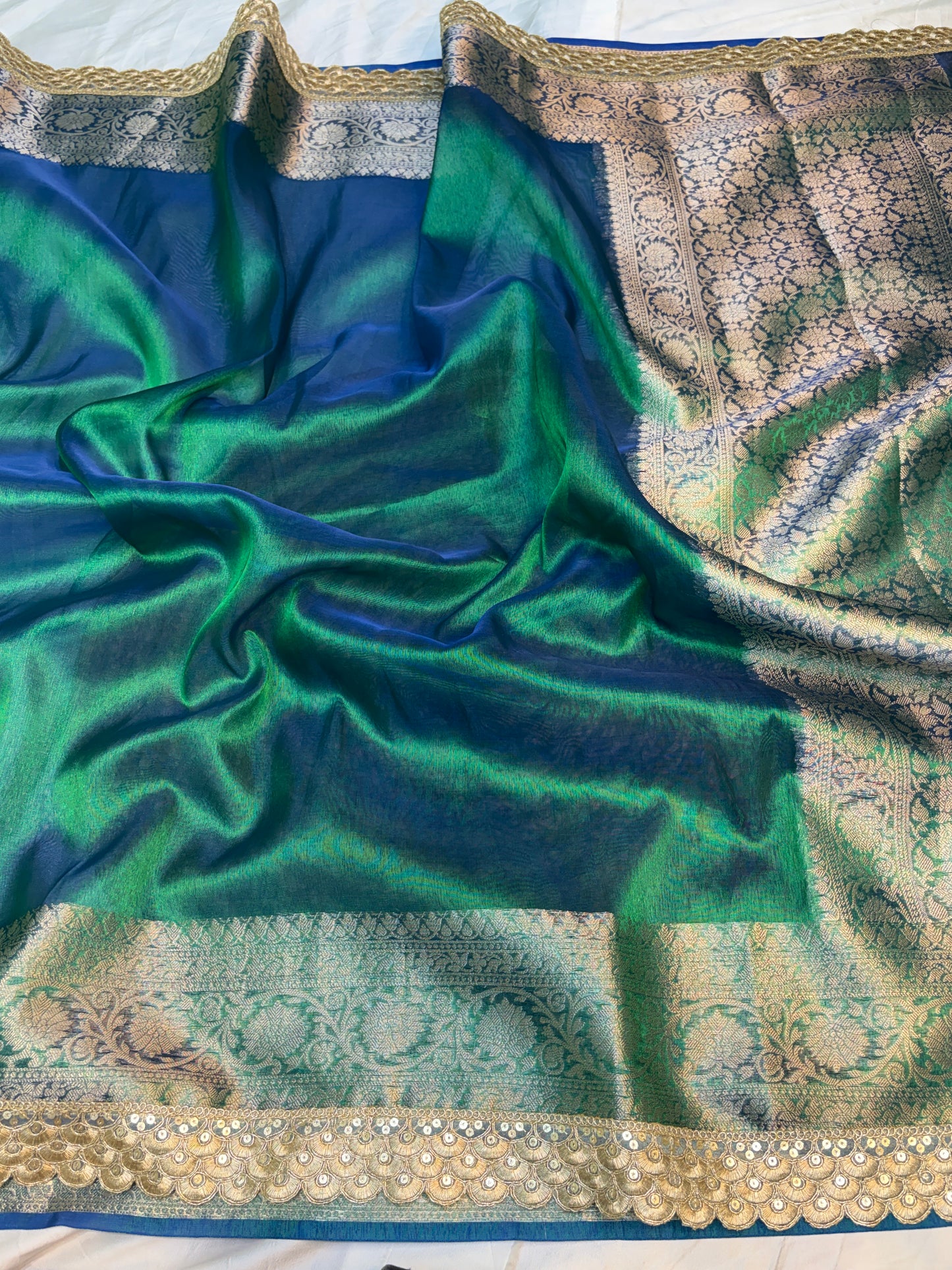 Metallic Peacock tissue silk saree with intricate lace work